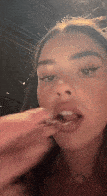 a close up of a woman 's mouth with a toothpick in it