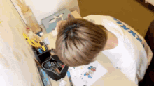 a person sitting at a desk with a t-shirt that says ' xerox ' on it