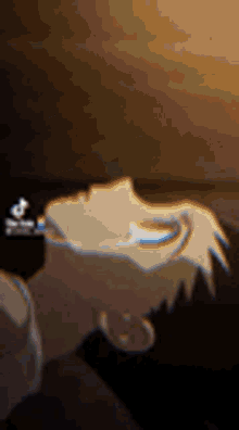 a close up of a person 's face in a dark room with a blurred background .
