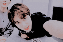 a boy wearing a black t-shirt that says ' seoul a ' on it