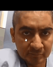 a close up of a man 's face with an arrow pointing at his eye