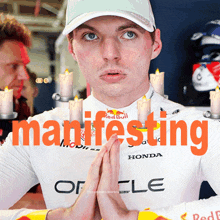 a man wearing a white shirt with the word manifesting written on it