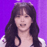 a girl with pigtails and a pearl necklace is smiling