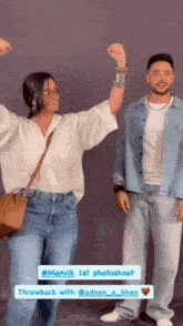 a man and a woman are standing next to each other with their hands in the air ..