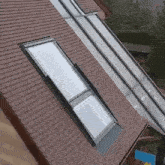 an aerial view of a roof with a skylight and gutter .