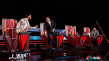 a group of people on a stage with a sign that says i want nbc