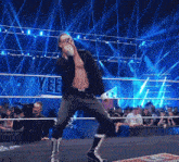 a man in a wrestling ring with the word yee on the wall