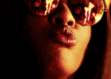 a close up of a woman wearing sunglasses
