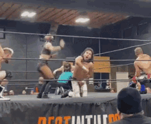 a wrestling match is going on in a ring with a sign that says decathlon