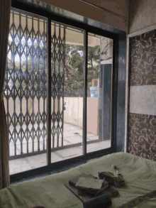 a room with a couch and a window with a fence behind it
