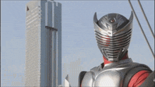 a man in a superhero costume stands in front of a tall building