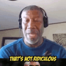 a man wearing headphones is making a funny face while talking on a video call .