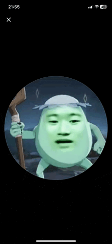 a phone screen shows a green cartoon character with a hat