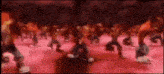 a group of people are dancing on a red carpet in a dark room .