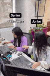 two women sit at a desk with lenovo laptops and one has 99 problems