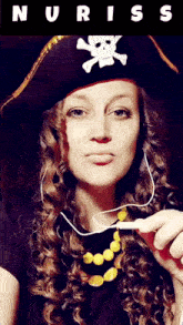 a woman wearing a pirate hat with a skull and crossbones design