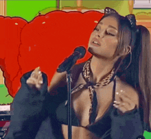 a woman in a black bikini is singing into a microphone .