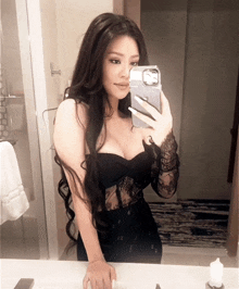 a woman taking a picture of herself in a mirror with an iphone case
