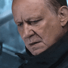 a close up of a man 's face with his eyes closed