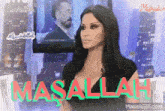 a woman is sitting in front of a television with the word masallah on it