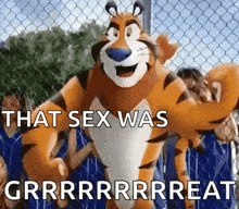 tony the tiger is standing in front of a chain link fence with a group of people behind him .