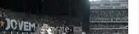 a blurred image of a stadium with a banner that says jovem