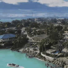 an aerial view of a residential area with a boat floating on the water