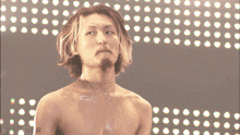 a shirtless man with a tattoo on his shoulder that says 12