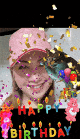 a woman in a pink hat is surrounded by birthday candles