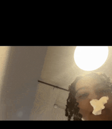 a close up of a woman 's face with a light behind her