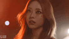 a close up of a woman 's face with the word luw on the bottom left
