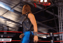 a man in a wrestling ring with a sign that says ' network ' on it