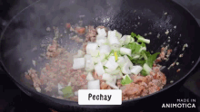 a pan of food is being cooked and the word pechay is on the bottom