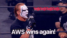 a wrestler with aws wins again written on the bottom of his face