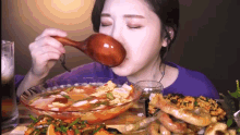 a woman eating food with a wooden spoon in her mouth