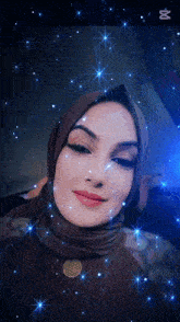 a woman wearing a hijab and a flower of life necklace is surrounded by blue stars