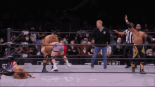 a man in a wrestling ring with the word elite on the wall