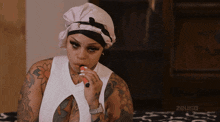 a woman smoking an electronic cigarette with a zeus logo in the corner