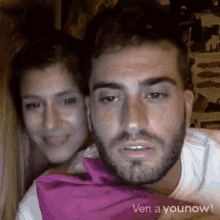 a man and a woman are sitting next to each other and the words ven a younow are on the bottom right