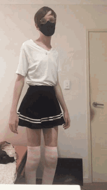 a young man wearing a mask and knee high socks
