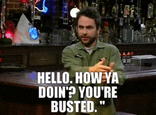 a man in a green shirt says hello how ya doin ' you 're busted ..