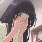 a girl covering her face with a phone that says ' lg ' on it