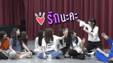 a girl in a happy funny free shirt sits in a circle with other girls