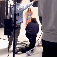 a woman in a colorful dress is being photographed