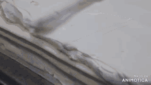 a large piece of cake is sitting on a table with the words made in animotica on the bottom