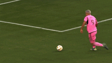 a soccer player with the number 2 on his jersey kicks the ball