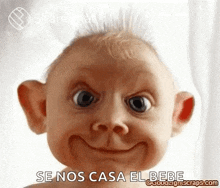 a baby is making a funny face with a big smile on its face .