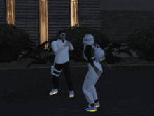 a man and a woman are walking down the street at night