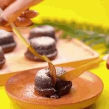 a person is dipping a chocolate cake with a fork