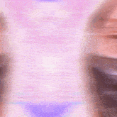 a blurred image of a person 's face with a pink and purple background